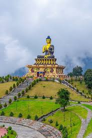 Giant golden seated Buddha statue on a landscaped hilltop in the Sikkim hills
