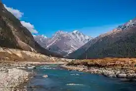 River flowing through Yumthang Valley with snow-capped mountains near Lachung