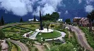 Batasia Loop garden with circular flower beds and the Gorkha War Memorial in Darjeeling